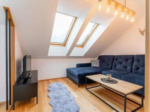 a living room with a blue couch and a table at Bösenstein in Hohentauern