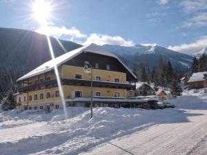 a large building on top of a snow covered mountain at Bösenstein in Hohentauern