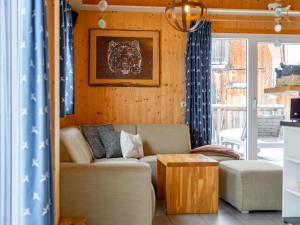 a living room with a couch and a table at Bärenschanze in Hohentauern
