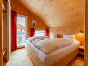 a bedroom with a bed in a wooden room at Bärenschanze in Hohentauern