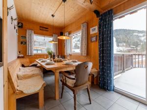 a dining room with a table and a balcony at Bärenschanze in Hohentauern