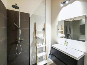 a bathroom with a shower and a sink and a mirror at SeeZeit am Pressegger See in Lake Pressegg