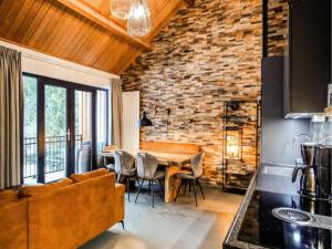 a kitchen and dining room with a brick wall at SeeZeit am Pressegger See in Lake Pressegg