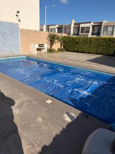 a swimming pool with a blue tarp on it at Casa spello in Gómez