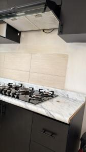 a stove top in a kitchen with a counter top at Casa spello in Gómez