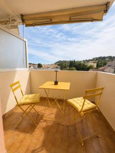 a table and two chairs on a balcony at Lovely studio with balcony - central location in Cavalaire-sur-Mer