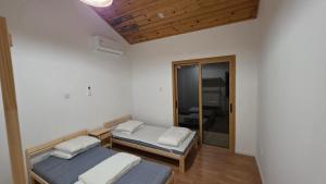 a room with two beds and a mirror at Platres Villas in Kato Platres +58 photos