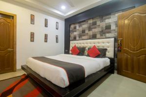a bedroom with a large bed with red pillows at Hotel OThe Blu Bell in Guwahati +48 photos