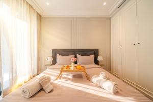 a bedroom with a bed with a tray of fruit on it at VIVASTAY Casablanca -Corniche Le claridge Emerauld with gym and rooftop in Casablanca
