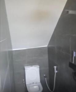 a bathroom with a urinal in a bathroom stall at Wrens cosy home in Diani Beach