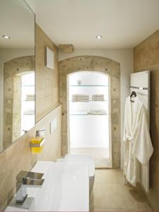 a bathroom with a white sink and a mirror at Domresidenz Regensburg in Regensburg