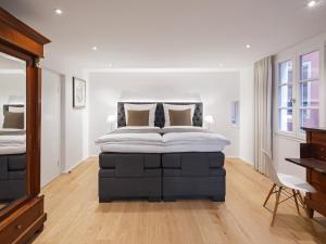 a bedroom with a large bed and a desk at Domresidenz Regensburg in Regensburg +24 photos