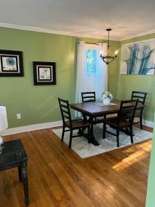 a dining room with green walls and a table and chairs at Cute 2 bedroom home ! in Augusta +22 photos