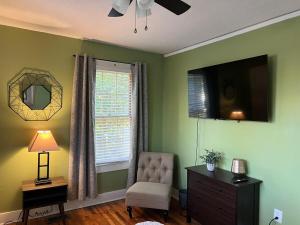 a living room with a chair and a television at Cute 2 bedroom home ! in Augusta