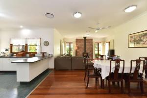 a kitchen and dining room with a table and chairs at La Sila Homestead on Marrowbone in Mount View