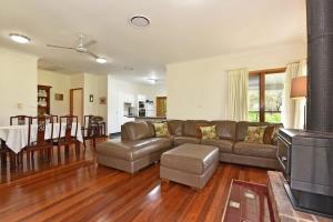 a living room with a couch and a table at La Sila Homestead on Marrowbone in Mount View
