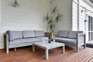 a couch and a coffee table on a porch at La Sila Homestead on Marrowbone in Mount View