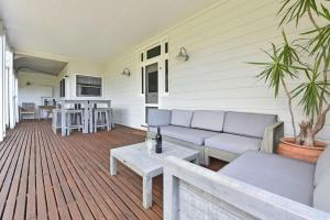 a porch with a couch and a table on a deck at La Sila Homestead on Marrowbone in Mount View +23 photos
