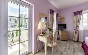a room with a desk and a window at Hotel L Odeon Phu My Hung in Ho Chi Minh City