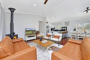 a living room with a couch and a fireplace at Lamp Estate in Greta