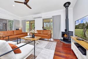 a living room with a couch and a fireplace at Lamp Estate in Greta