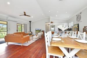a dining room and living room with a table and chairs at Lamp Estate in Greta