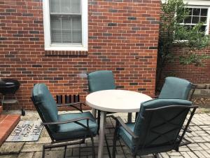 a table and chairs and a table and a brick wall at Cute 2 bedroom house in Augusta in Augusta