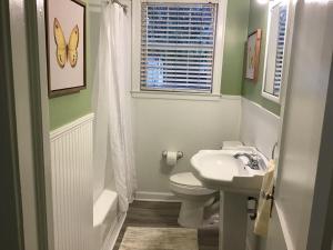 a bathroom with a sink and a toilet and a window at Cute 2 bedroom house in Augusta in Augusta +18 photos