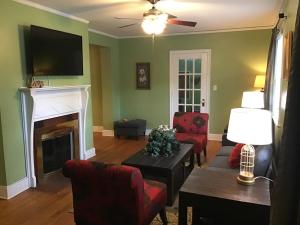 a living room with a couch and a fireplace at Cute 2 bedroom house in Augusta in Augusta