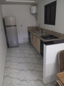 a kitchen with a refrigerator and a counter top at 925 تجزئة الفتح خريبكة 5 in Khouribga