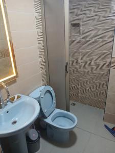a bathroom with a toilet and a sink at 925 تجزئة الفتح خريبكة 5 in Khouribga