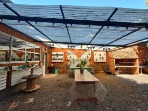 a patio with a wooden table and a brick wall at Mariposa 88 in Puerto Rico
