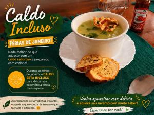 a sign with a bowl of soup and some bread at Pouso das Flores - Próximo a Maria Fumaça in Tiradentes