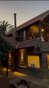 a large house with windows and a roof at Fashet alsalt-فشة السلط in Al Salt