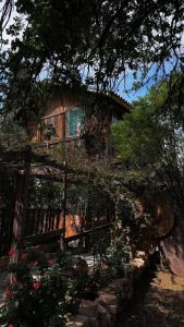 a house with a fence and flowers in front of it at Fashet alsalt-فشة السلط in Al Salt