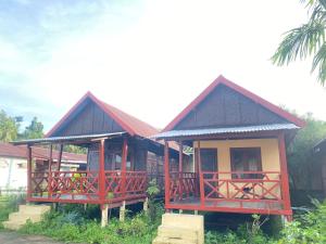 a small house with red accents in front of it at souksanh River Bungalow in Along