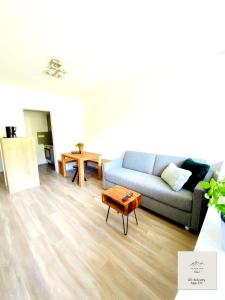 a living room with a couch and a coffee table at Panorama-Glück I & III in Garmisch-Partenkirchen