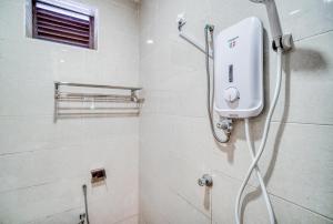 a shower in a bathroom with a shower head at Rivora Gopeng in Gopeng