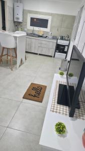 a kitchen with a table and a counter top at Departamento VMV in Río Grande