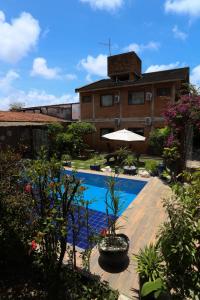a resort with a swimming pool and a building at Lumar Flats in Paulista