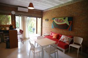 a living room with a red couch and a table at Lumar Flats in Paulista