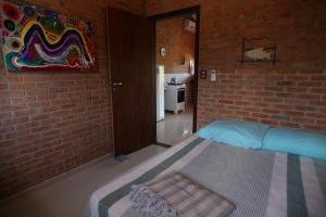 a bedroom with a brick wall and a bed in a room at Lumar Flats in Paulista +39 photos
