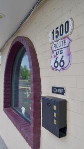 a building with an arched window and a pay phone at Relax Inn in Flagstaff