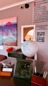a desk with a clock and a globe on it at Relax Inn in Flagstaff