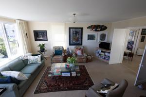 a living room with a couch and a table at Khandallah Harbour View BnB in Wellington