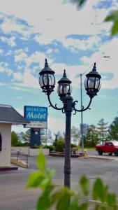 a light pole with two lights on it in a parking lot at Relax Inn in Flagstaff