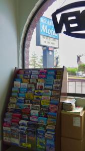 a pile of books stacked on top of each other at Relax Inn in Flagstaff +32 photos