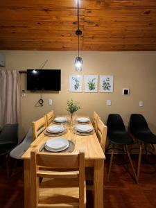 a dining room with a wooden table and chairs at Mariposa 88 in Puerto Rico