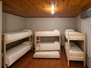 three bunk beds in a room with a ceiling at Mariposa 88 in Puerto Rico