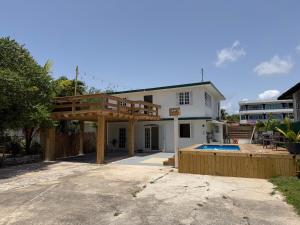 a house with a swimming pool in front of it at Casa Brisa Beach House in Dorado